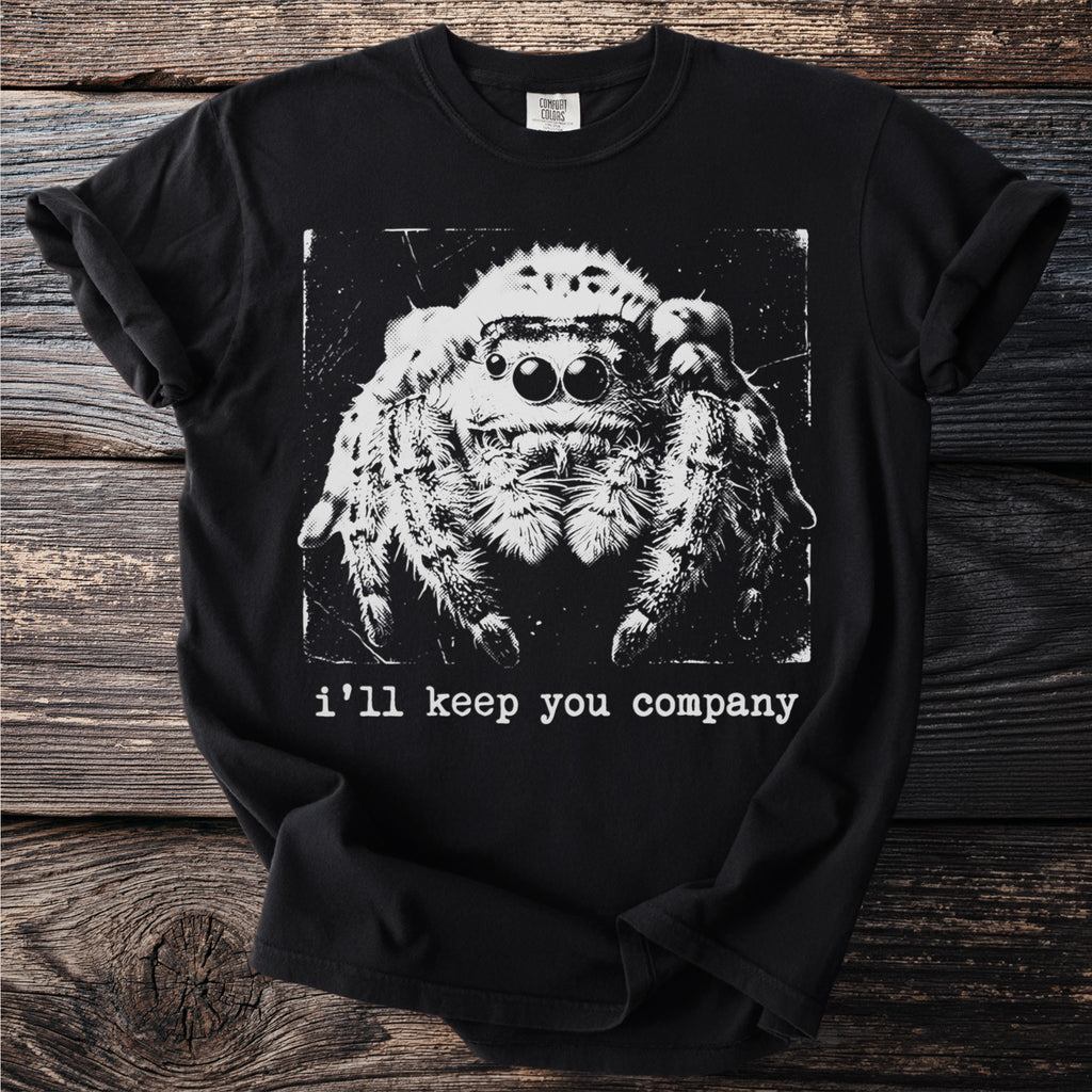 Black t-shirt with a black and white graphic of a jumping spider above the text "i'll keep you company".