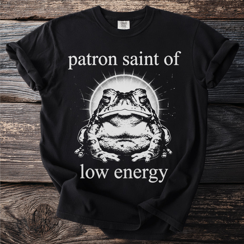 Black t-shirt with a toad graphic and text saying "patron saint of low energy".