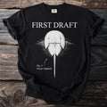 Black t-shirt with "FIRST DRAFT" and horseshoe crab graphic "Fig. 1: Never Updated."