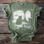 Green t-shirt graphic: black cat, moth, spider, and bugs with text "you're not alone there are bugs".