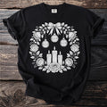 Black t-shirt with floral wreath, candles, and "Memento Mori" ornaments.