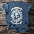 Dark blue t-shirt with a white graphic of a skull and crossbones and text.
