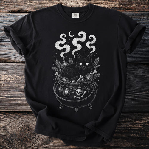 Black t-shirt with a black cat in a cauldron, surrounded by ornaments and bones.