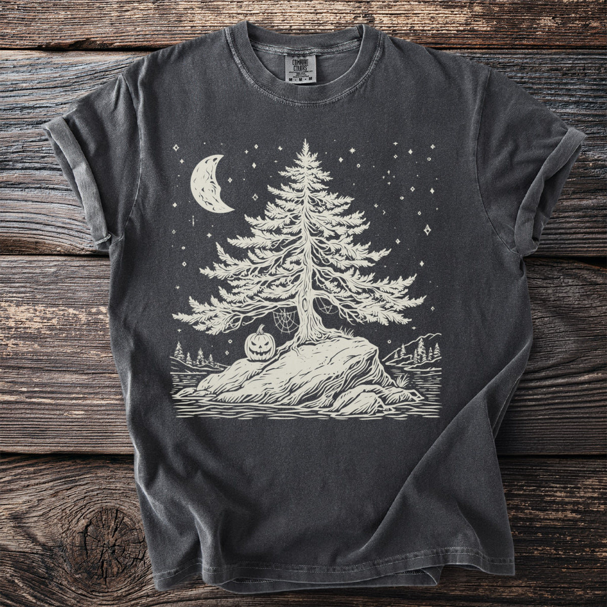 Dark grey t-shirt with a linocut-style graphic of a tree, moon, stars, and pumpkin.