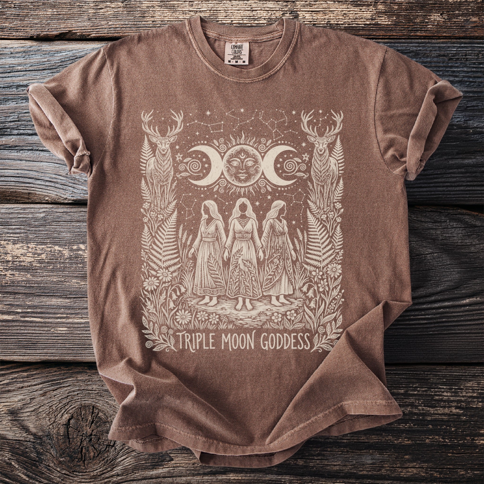 Brown t-shirt with a white graphic of the Triple Moon Goddess and deer.