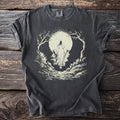 Dark t-shirt with a cream graphic of a robed figure in a forest under a moon.