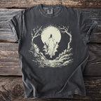 Dark t-shirt with a cream graphic of a robed figure in a forest under a moon.