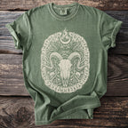 Green t-shirt with distressed ram skull, wings, moon, and rune design.