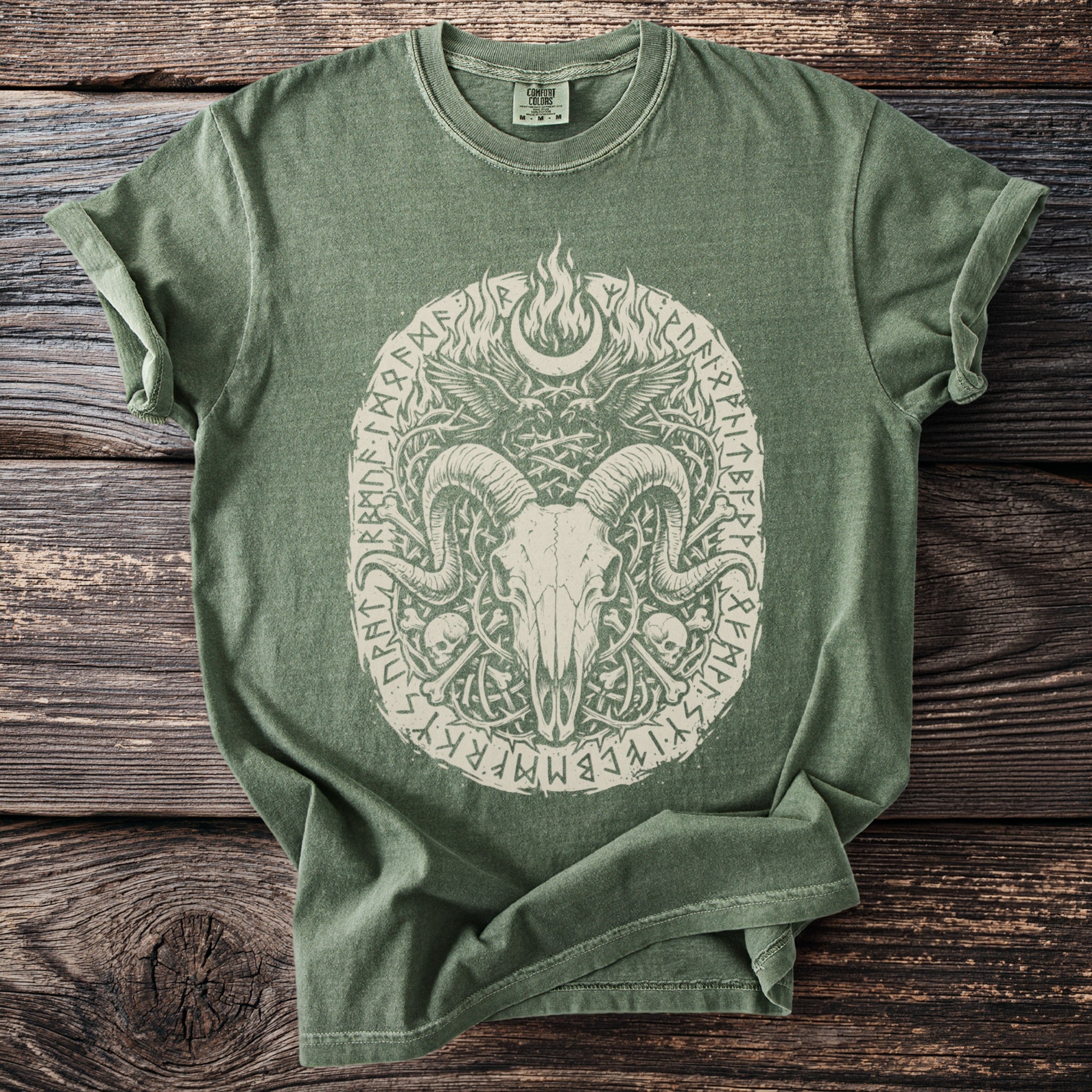 Green t-shirt with distressed ram skull, wings, moon, and rune design.