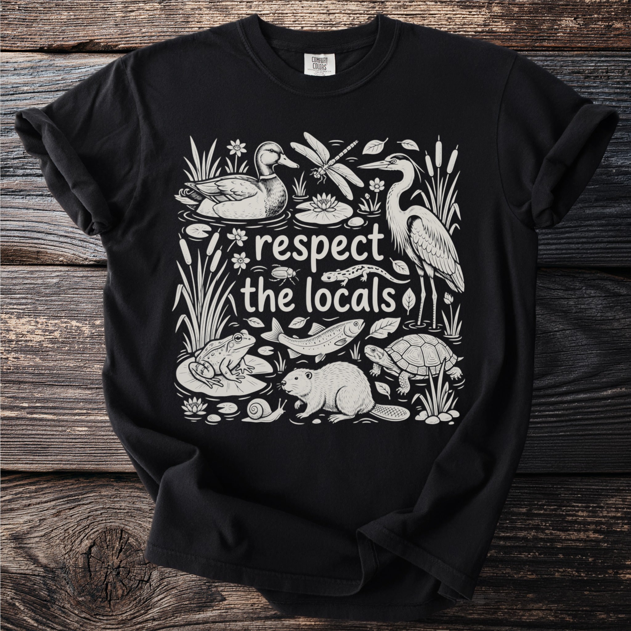 Black t-shirt with a line drawing of wildlife and the text "respect the locals".
