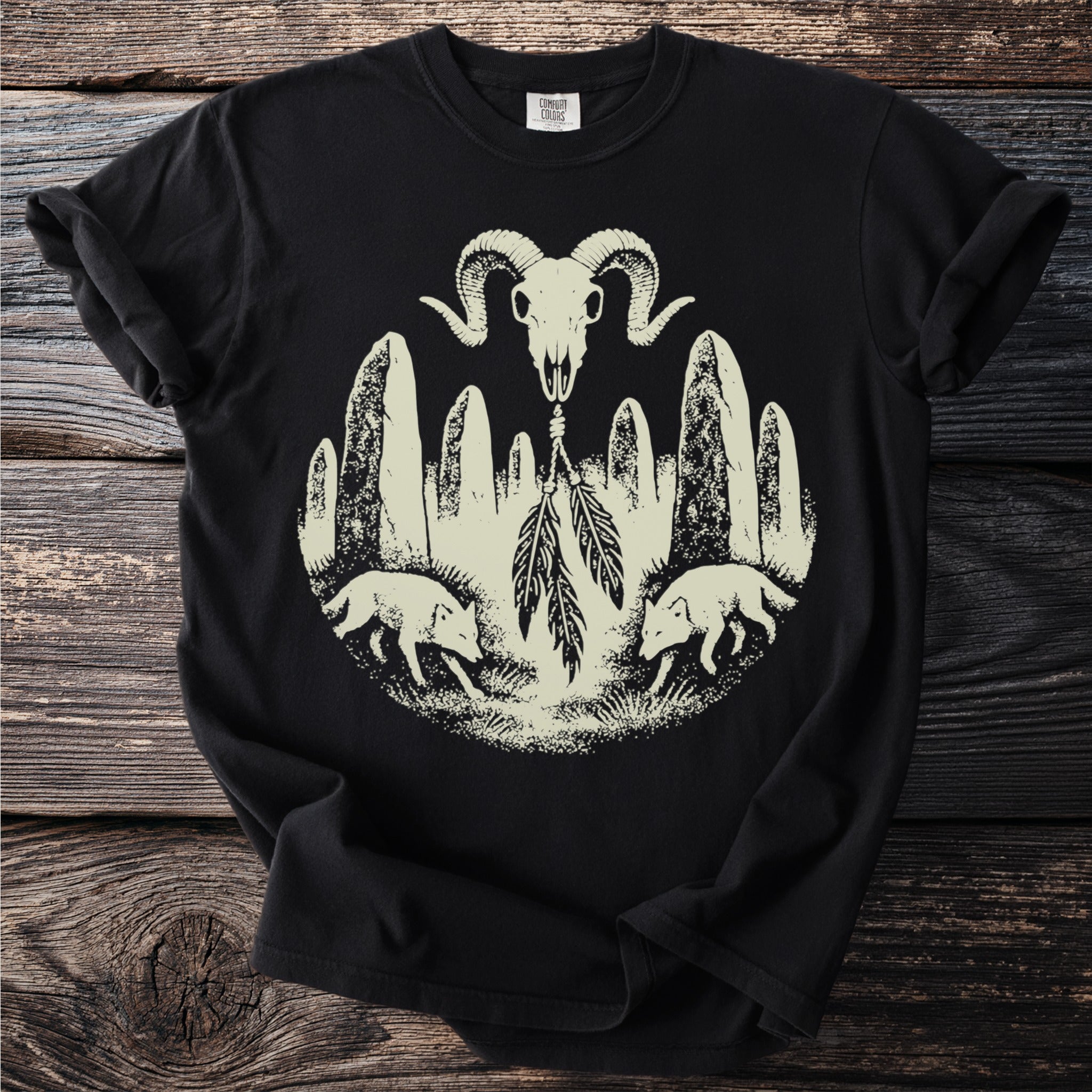 Black t-shirt with ram skull, stones, feathers, and wolves graphic.