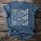 Blue t-shirt with white outline drawing of butterflies and text "respect the locals".