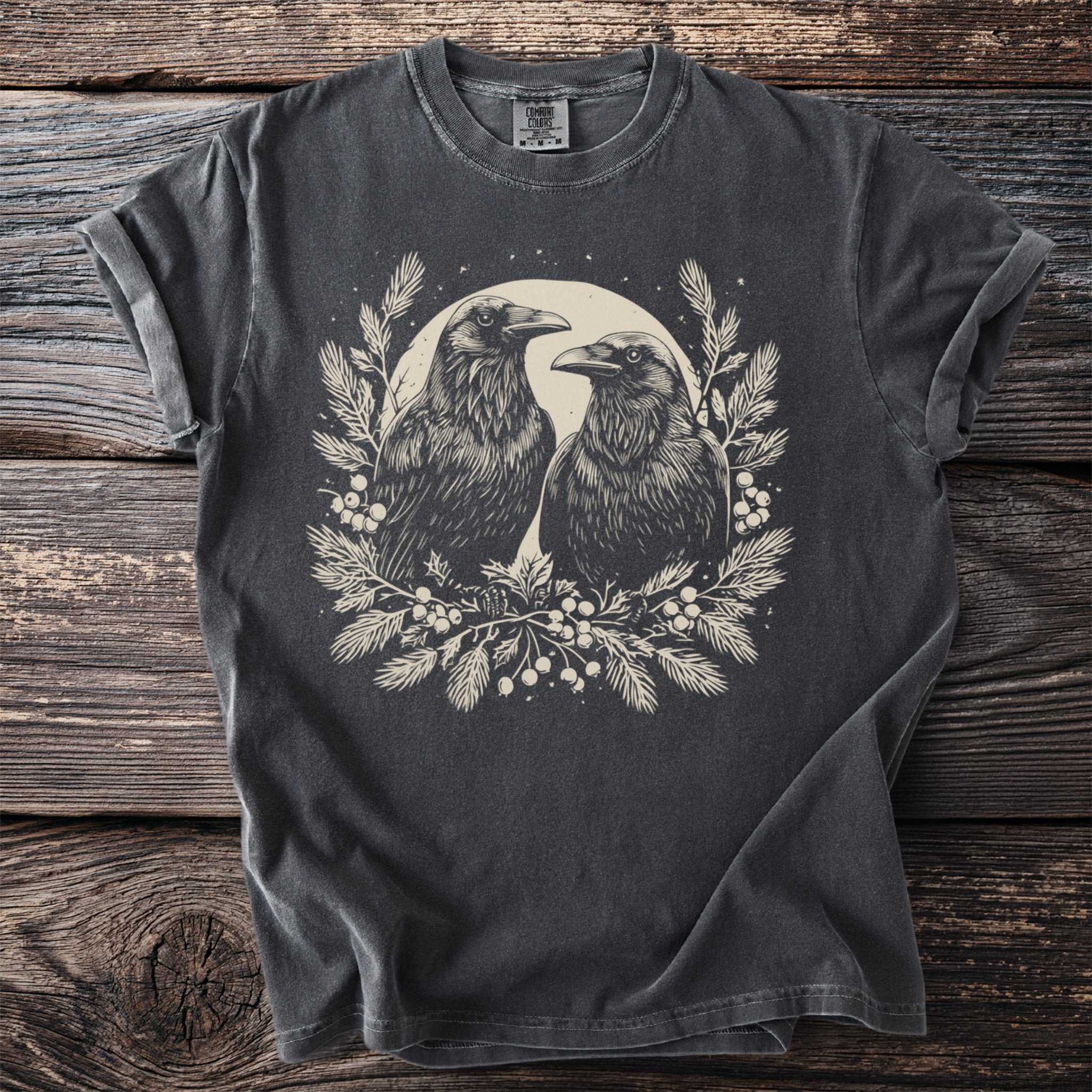 Dark grey t-shirt with two crows surrounded by foliage and berries.