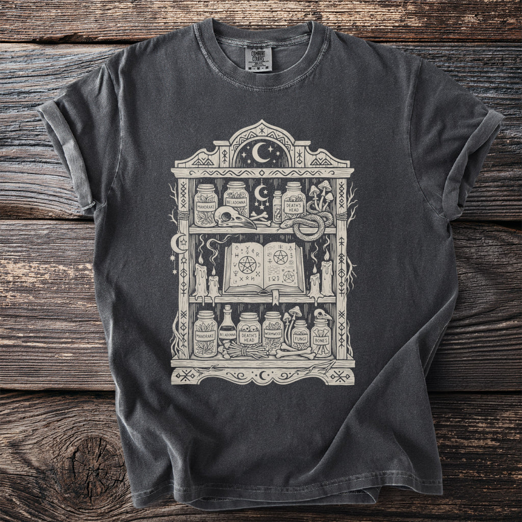 Dark grey t-shirt with cream occult-themed shelf graphic and jars.