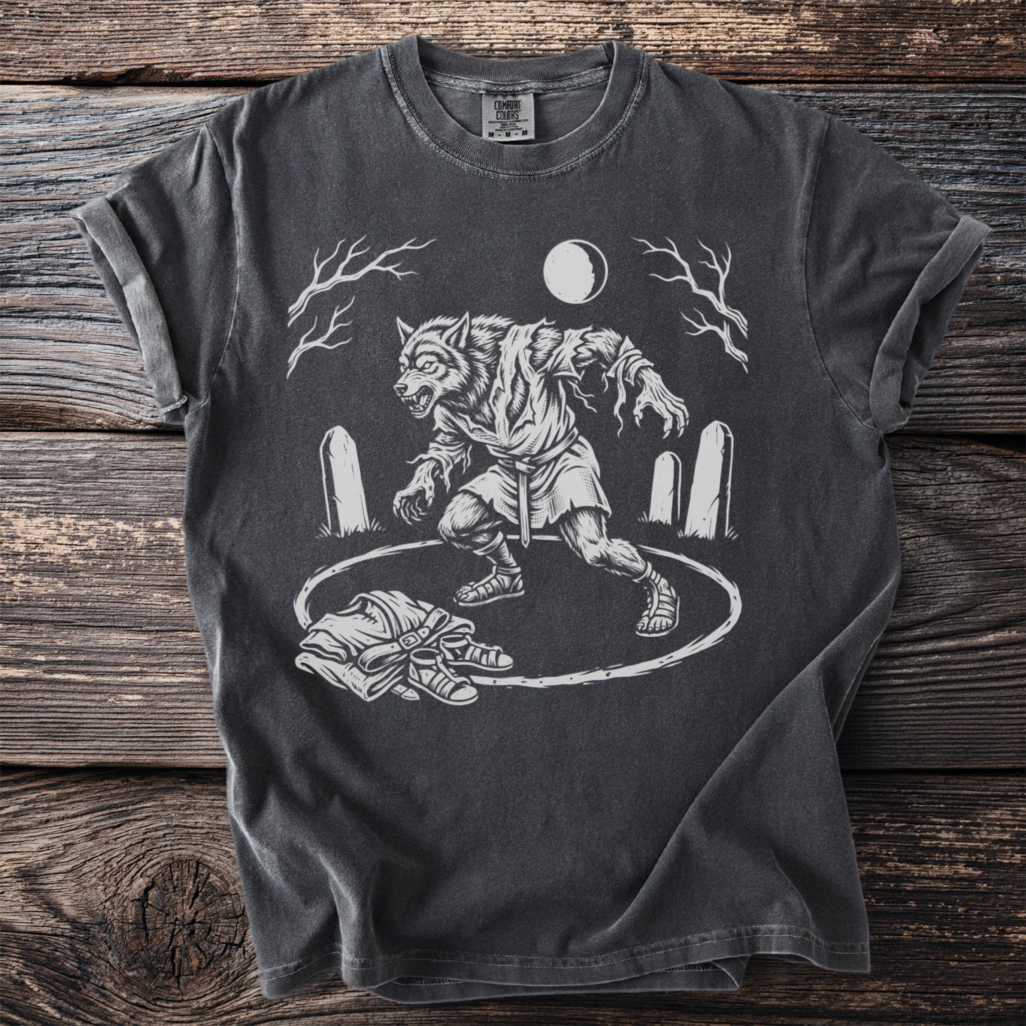 Werewolf graphic t-shirt with tombstones, moon, and discarded clothing.