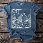 T-shirt with a white illustration of a ghost in a swamp with dragonflies and hanging jars.
