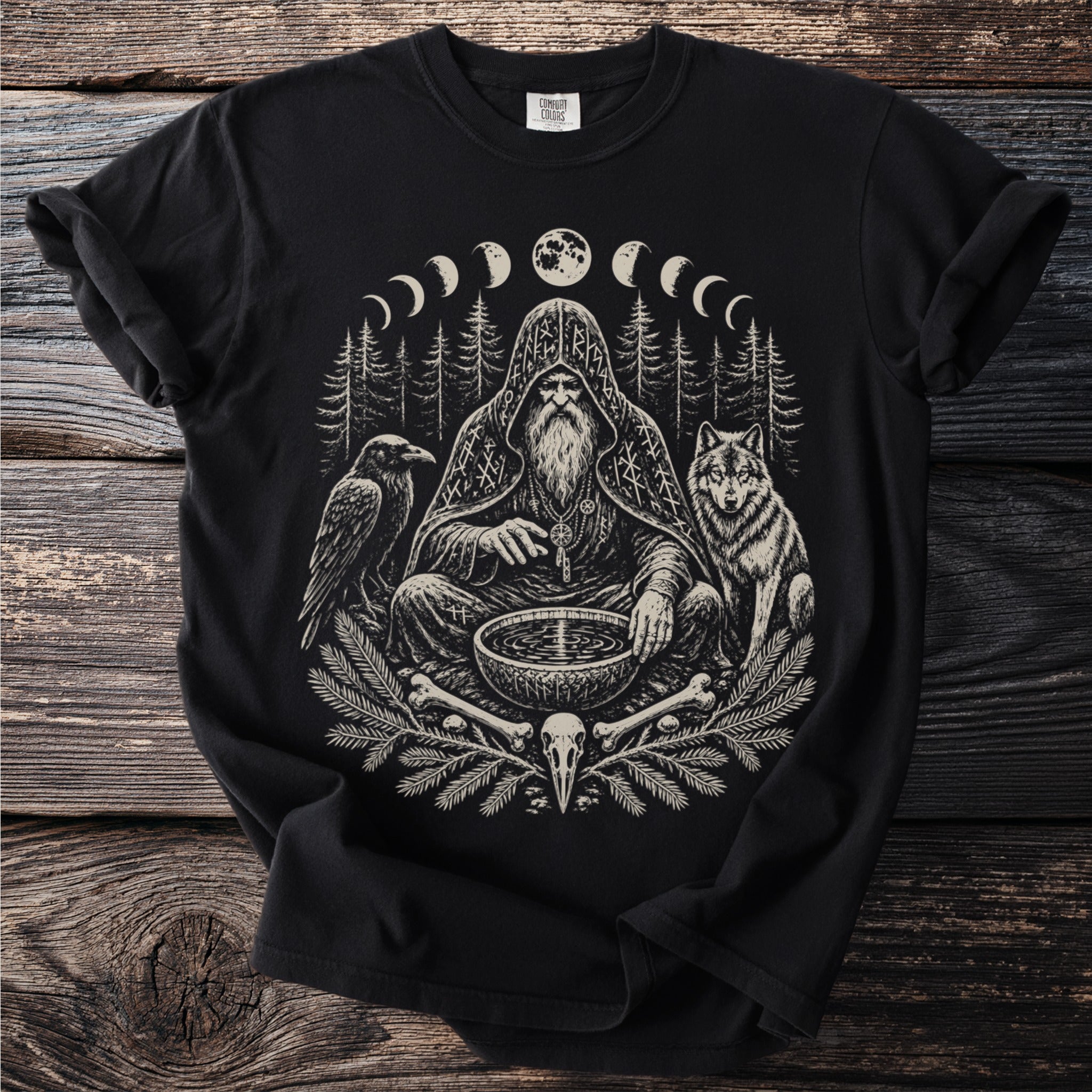 Black t-shirt print of a bearded man with a raven and wolf by a moon phase forest.