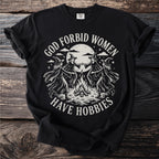 Black t-shirt with witches dancing around a bonfire, reading "God forbid women have hobbies."