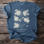 Blue shirt with a central illustration of various heirloom apples and text.