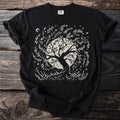 Black t-shirt with a cream graphic of a black cat in a witch hat, full moon, bats, and curling smoke.