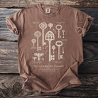 Brown t-shirt with illustration of "The Locksmith's Cabinet" historical keys.