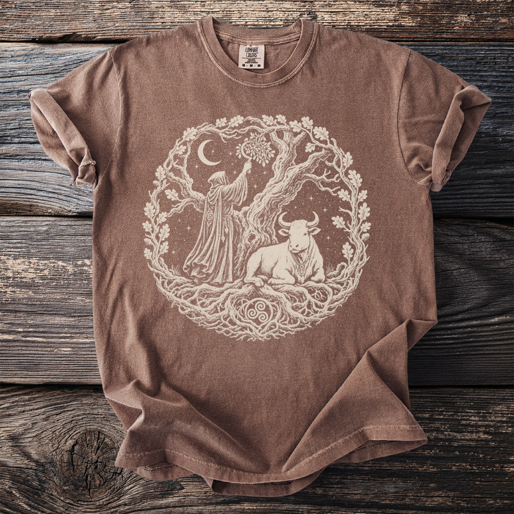 Brown t-shirt featuring a circular design of a robed figure, a bull, and a tree with ornate roots.