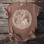 Brown t-shirt featuring a circular design of a robed figure, a bull, and a tree with ornate roots.