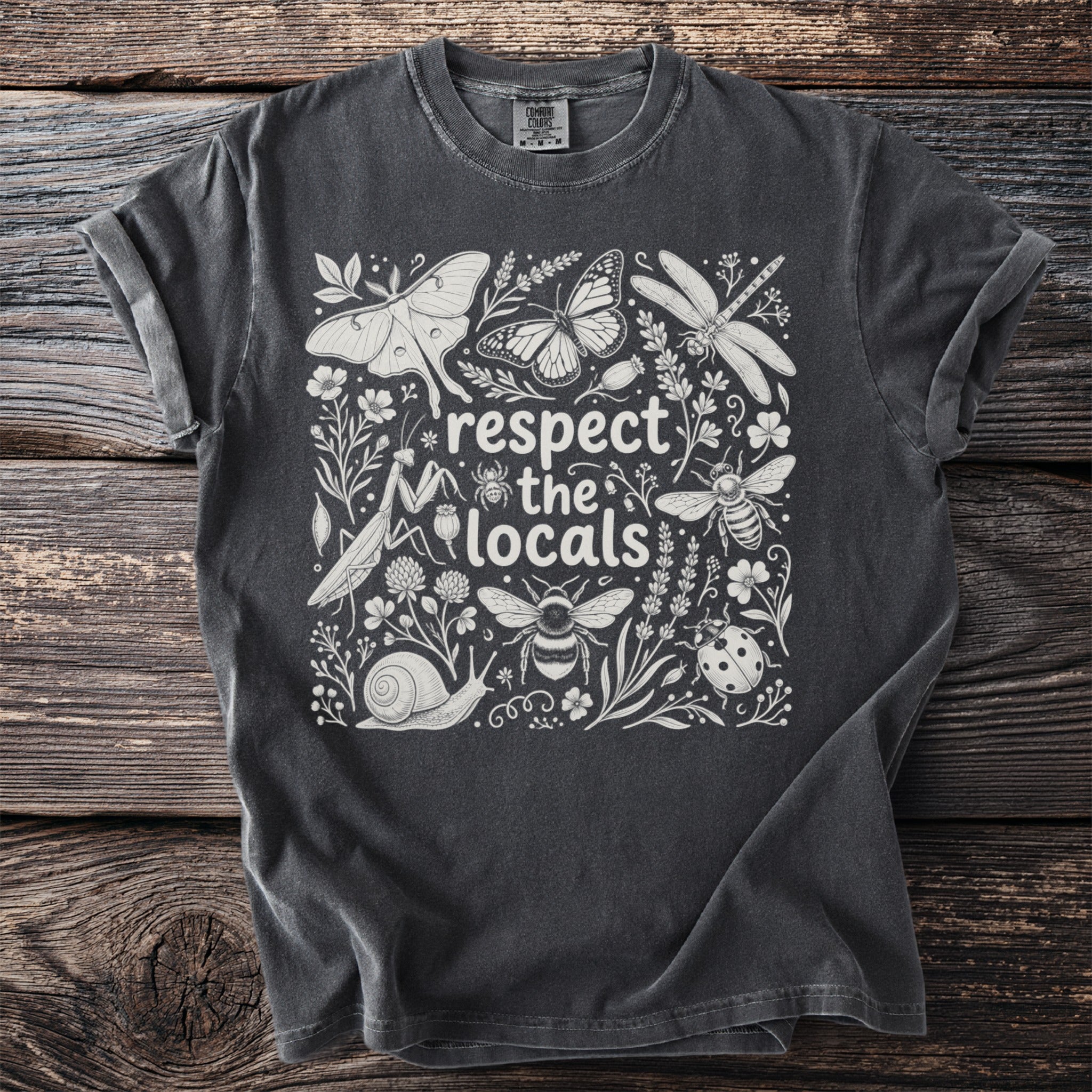 Charcoal t-shirt with white graphic of insects and plants, reading "respect the locals."