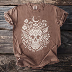 Brown t-shirt with white skull, moth, and floral design, featuring a moon and stars.