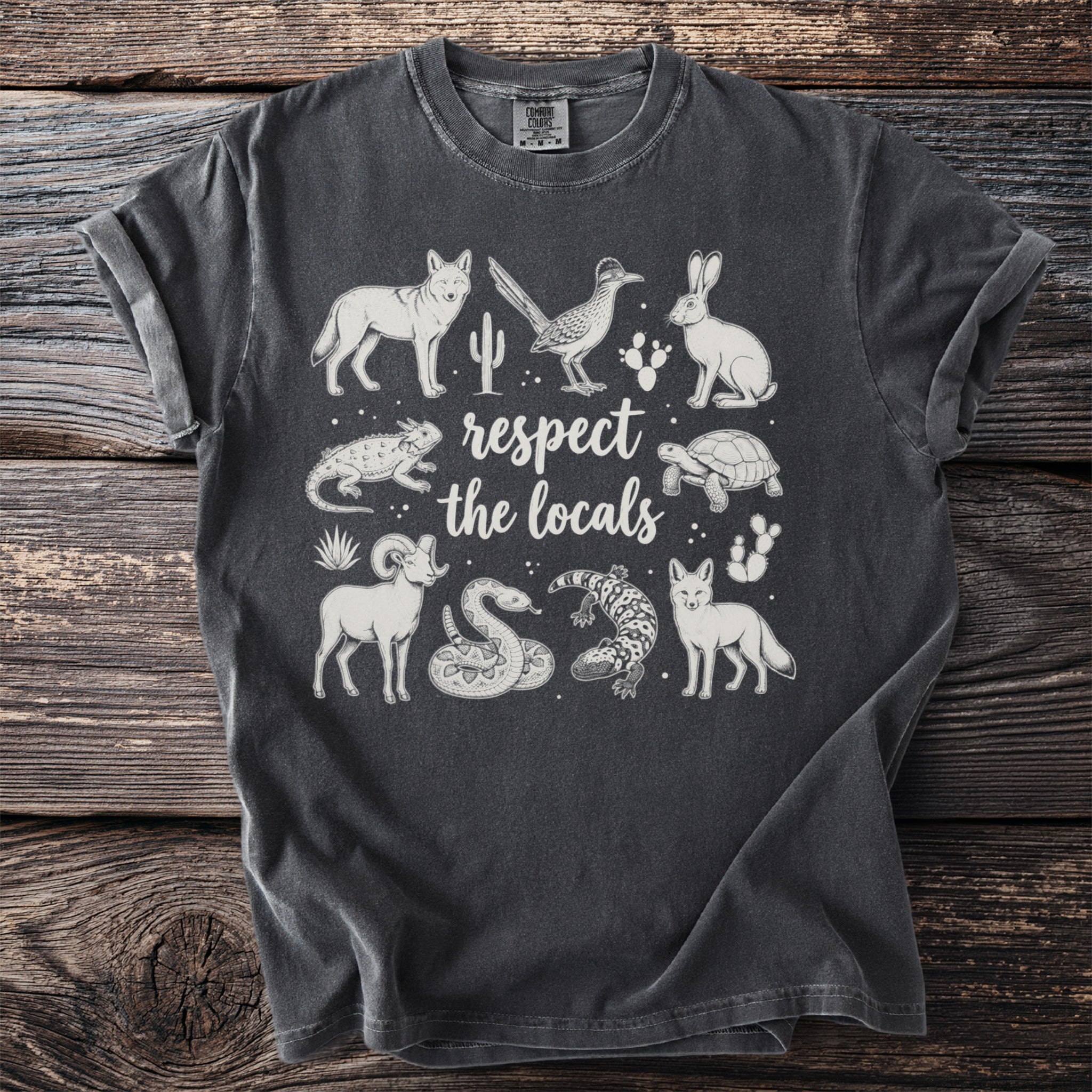 Dark grey t-shirt with desert animals and "respect the locals" text.