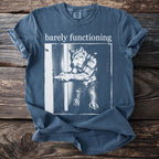 Blue t-shirt with white text "barely functioning" and a graphic of a wolf in jeans holding a remote.