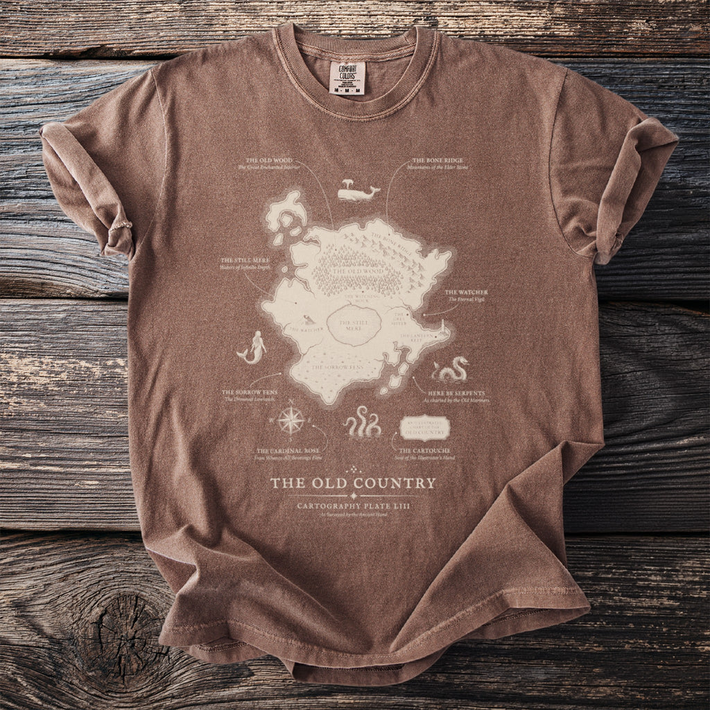 Brown t-shirt with a map of "The Old Country" featuring mountains, woods, and water.