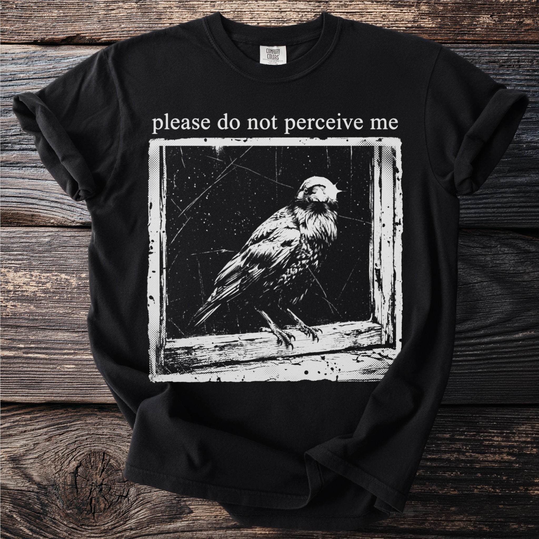 Black t-shirt with bird graphic and text "please do not perceive me".