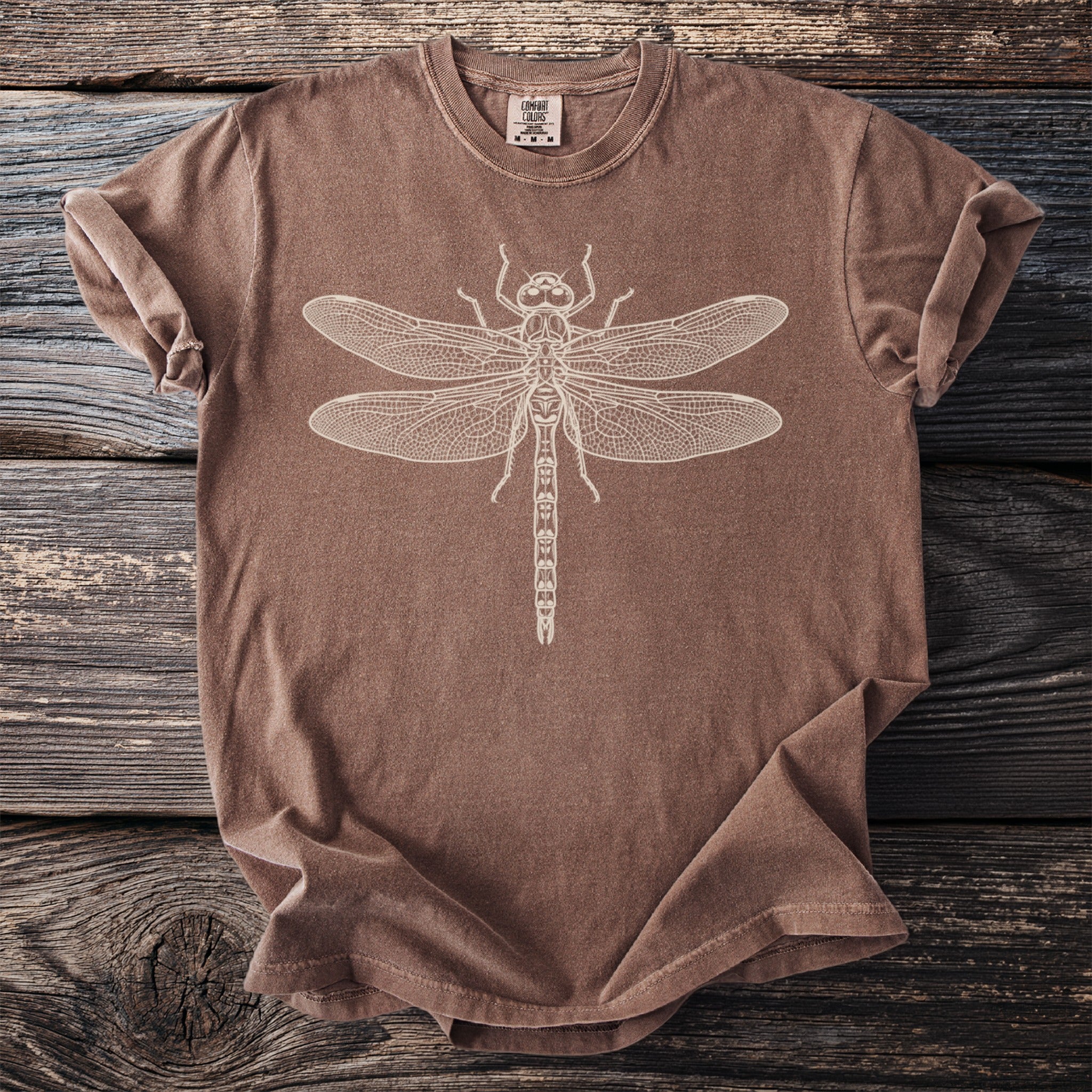 Brown t-shirt with a cream-colored dragonfly graphic and Comfort Colors label.