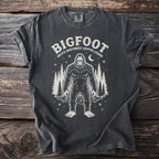 Bigfoot graphic tee with text "Bigfoot Pacific Northwest Cryptid Legend" and trees.
