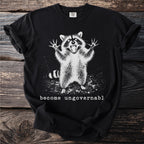 Black t-shirt with a startled raccoon graphic and the text "become ungovernable".