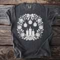 Dark gray t-shirt with white floral wreath, candles, and "Memento Mori" ornaments.