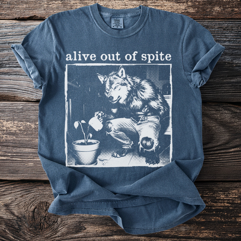 T-shirt with "alive out of spite" text and illustration of a werewolf watering a plant.