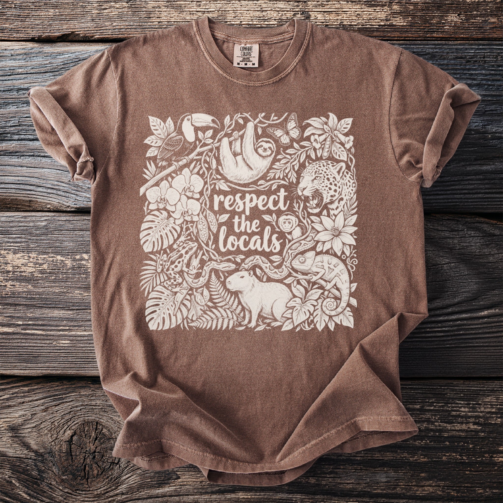 Brown t-shirt with "respect the locals" text and jungle animals in white print.