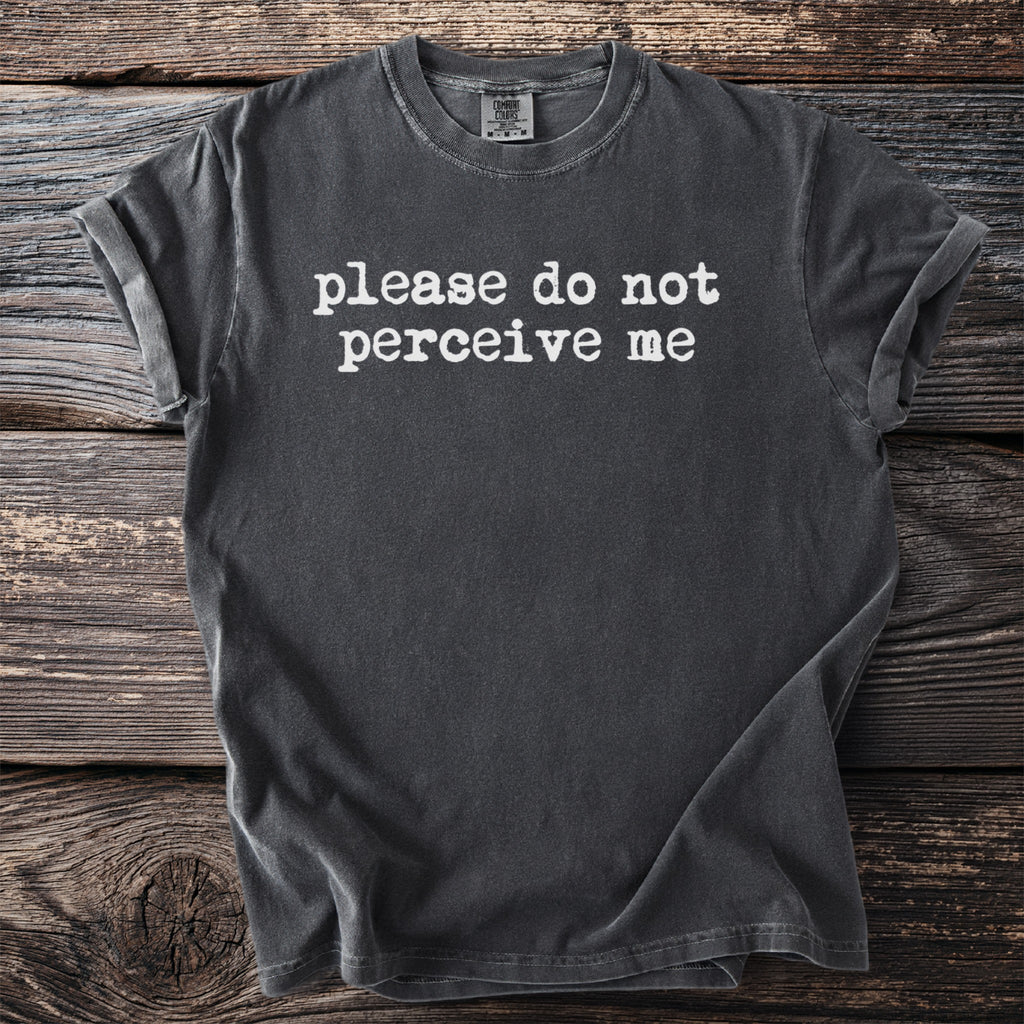 Dark gray t-shirt with white text reading "please do not perceive me."
