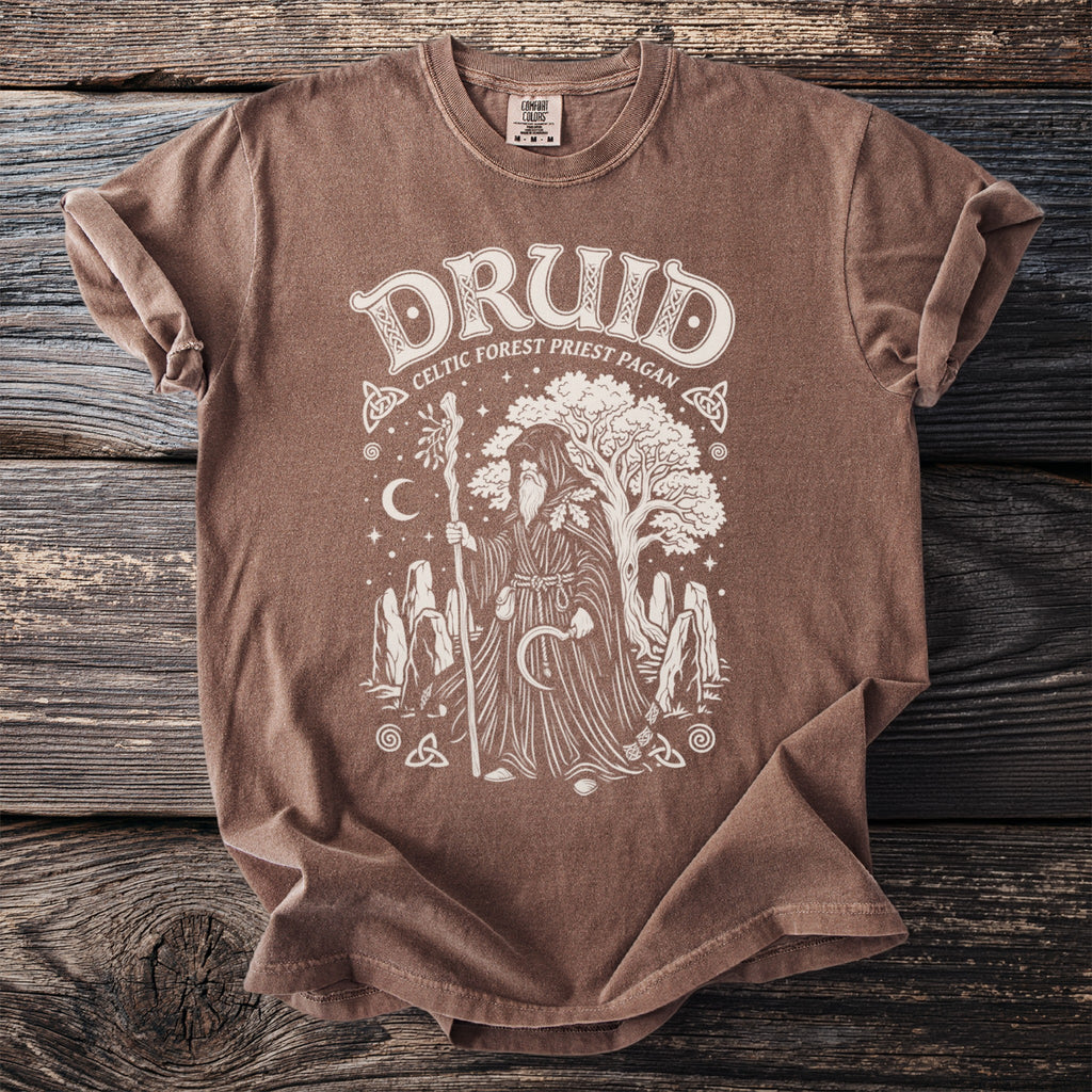 Brown t-shirt with white graphic of a druid, tree, moon, and stones.