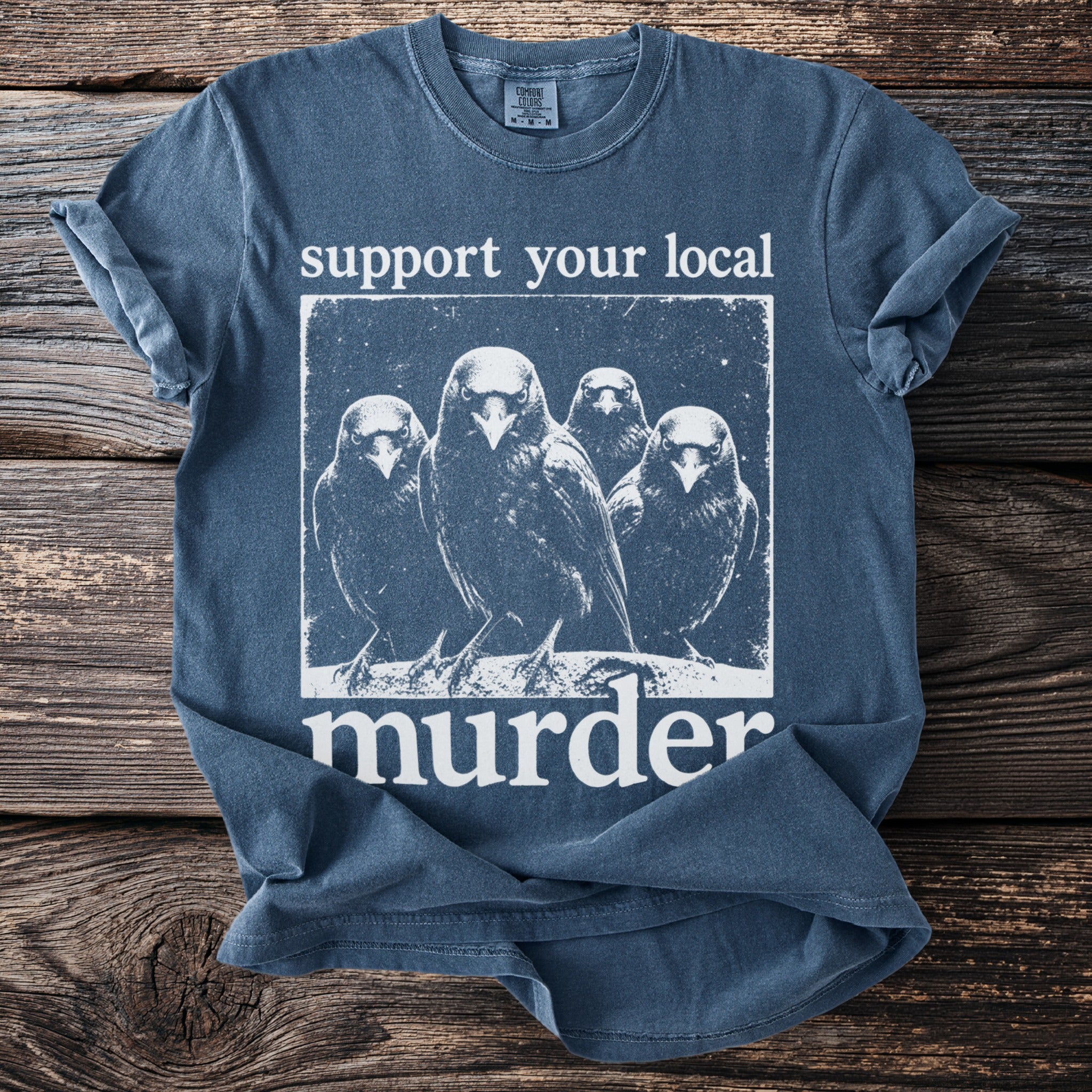 Blue t-shirt with white graphic of four crows and text "support your local murder."
