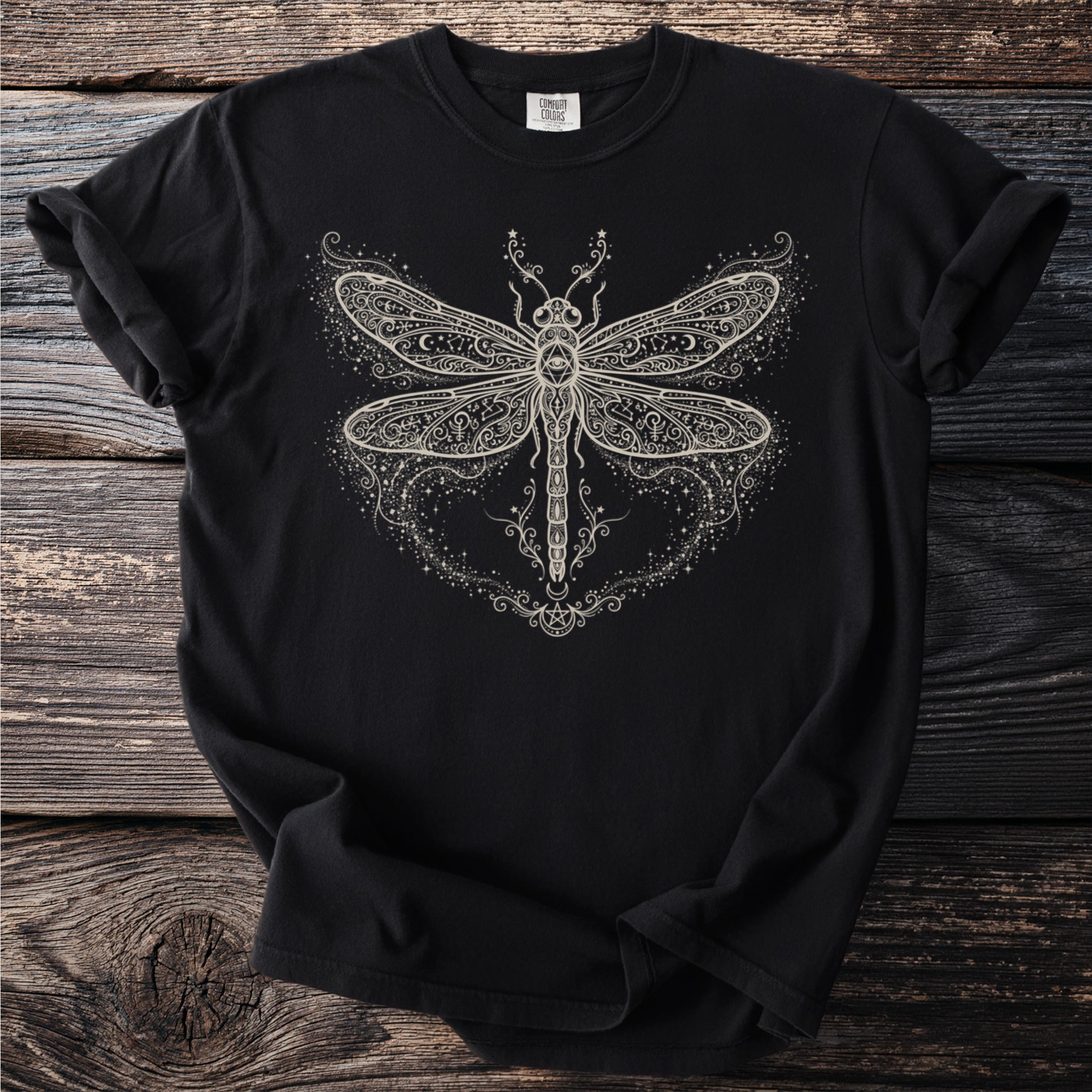 Black Comfort Colors t-shirt with a detailed white dragonfly and celestial design.