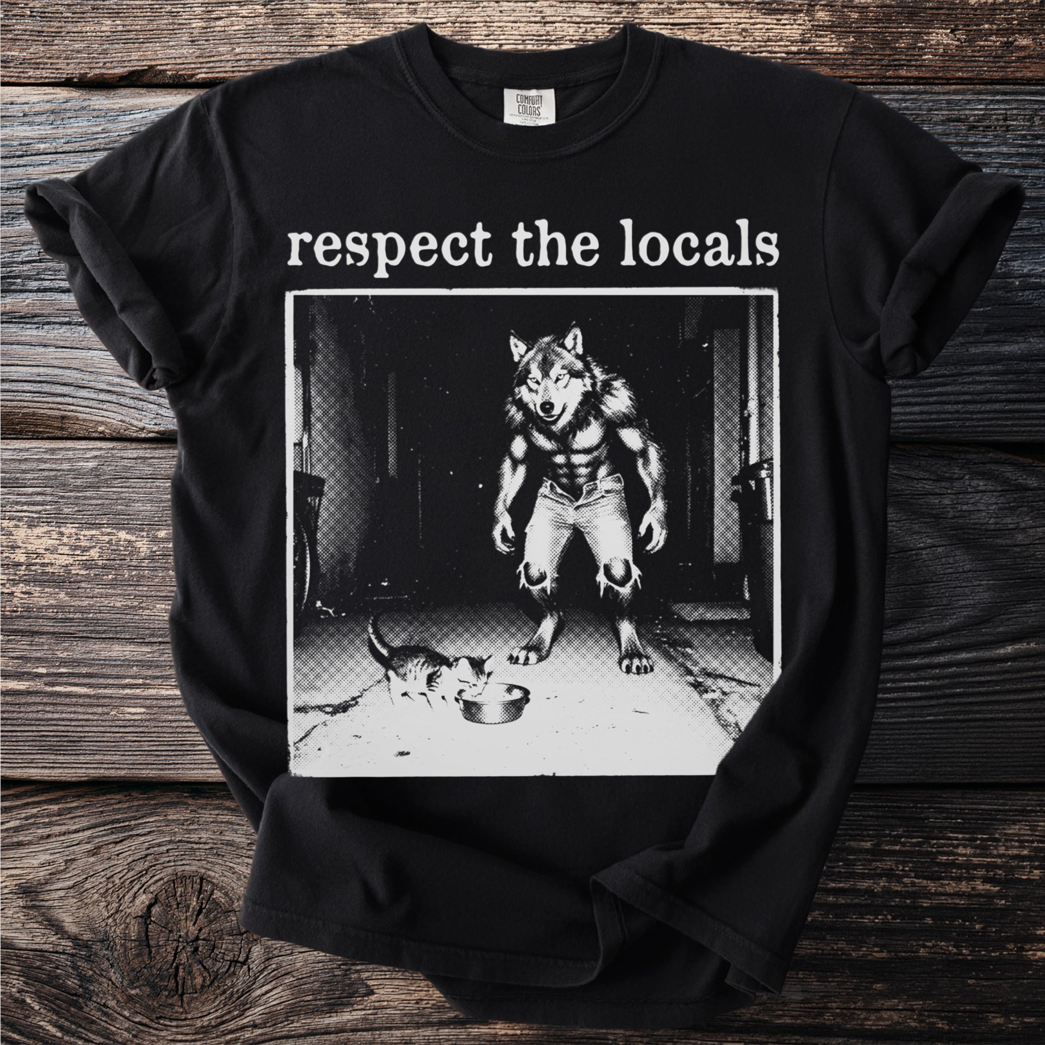 Black t-shirt with "respect the locals" and a werewolf watching a kitten eat.
