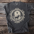 Pepper t-shirt with a forest elk beneath a north star inside a pinecone wreath.