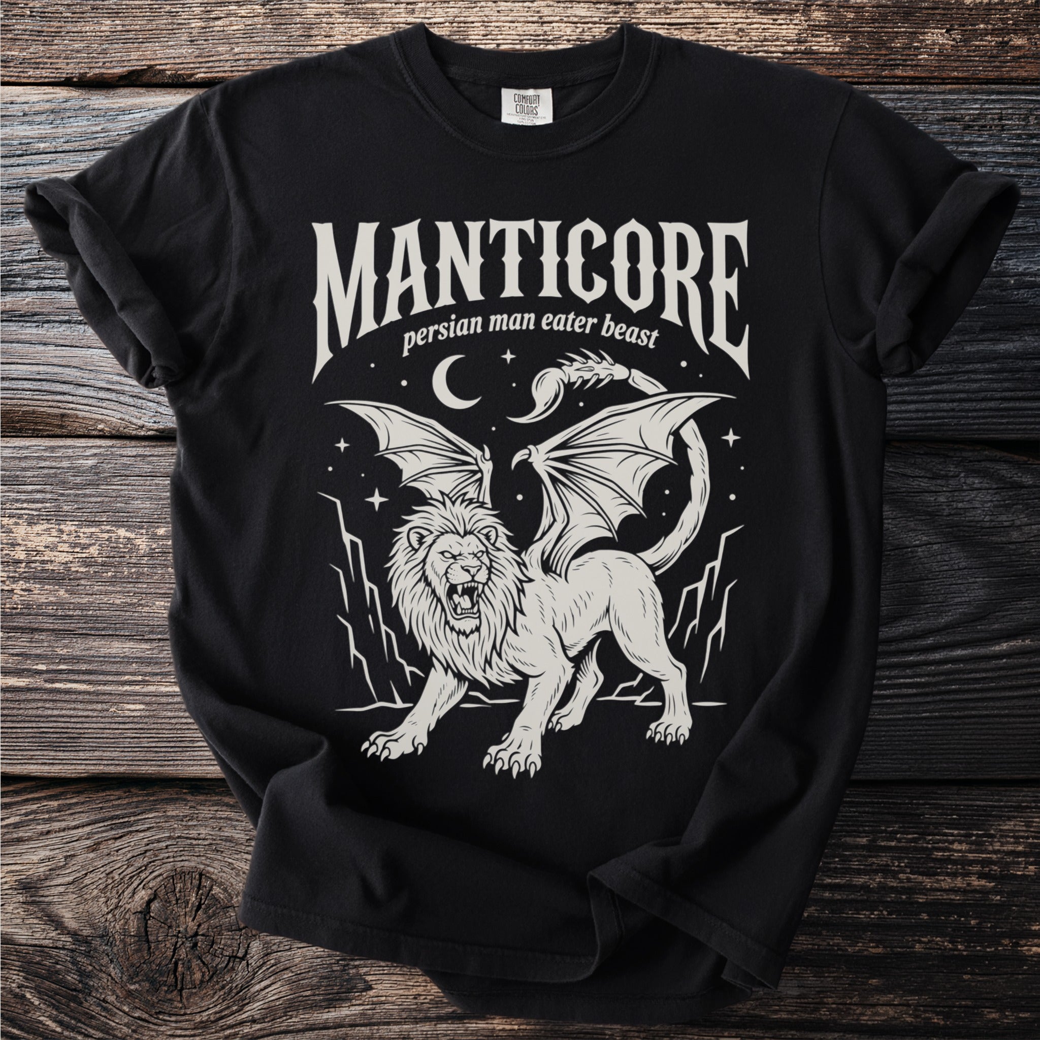 Black t-shirt with a white winged lion and text "MANTICORE Persian Man Eater Beast".