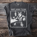 T-shirt with white text "not your type" over a drawing of a muscular werewolf sitting at a table with coffee.