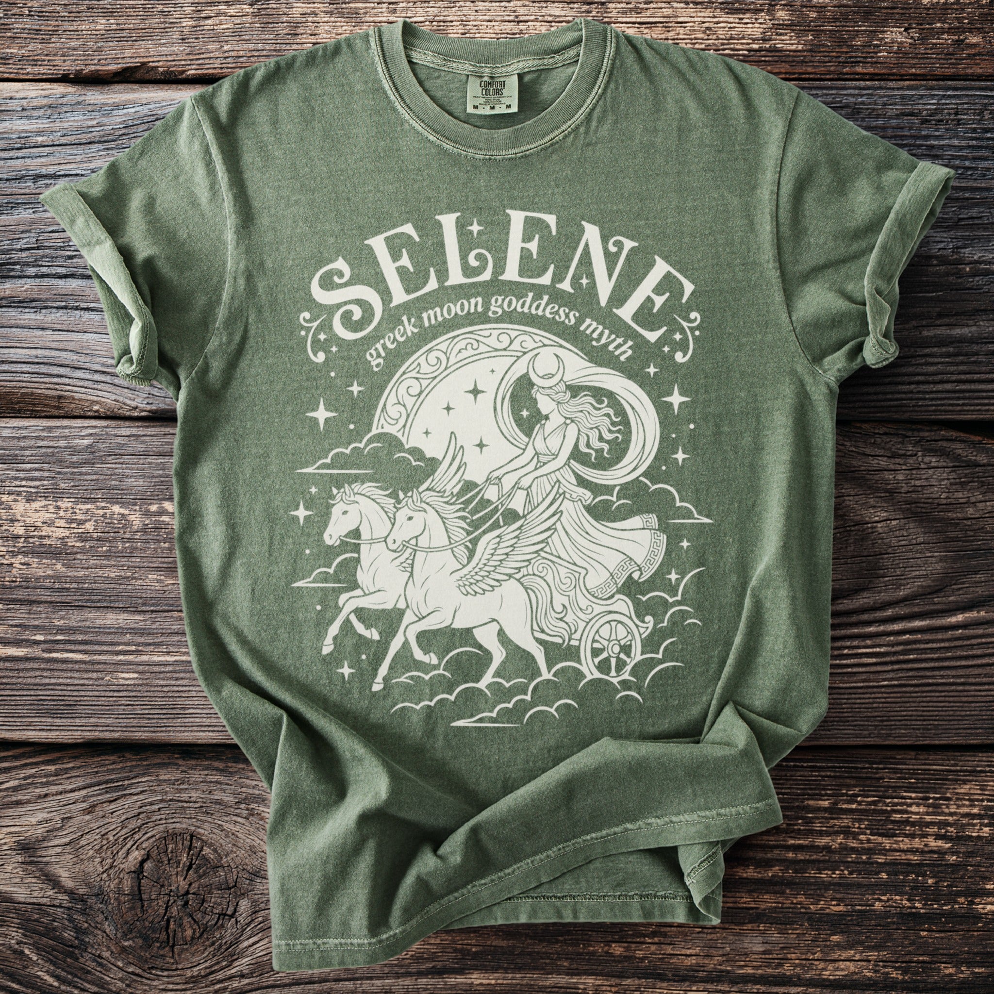 Green t-shirt with white graphic of Selene, Greek moon goddess, in chariot pulled by winged horses.