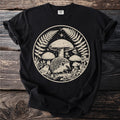 Black t-shirt with round forest graphic featuring hedgehog, bird, mushrooms, and ferns.