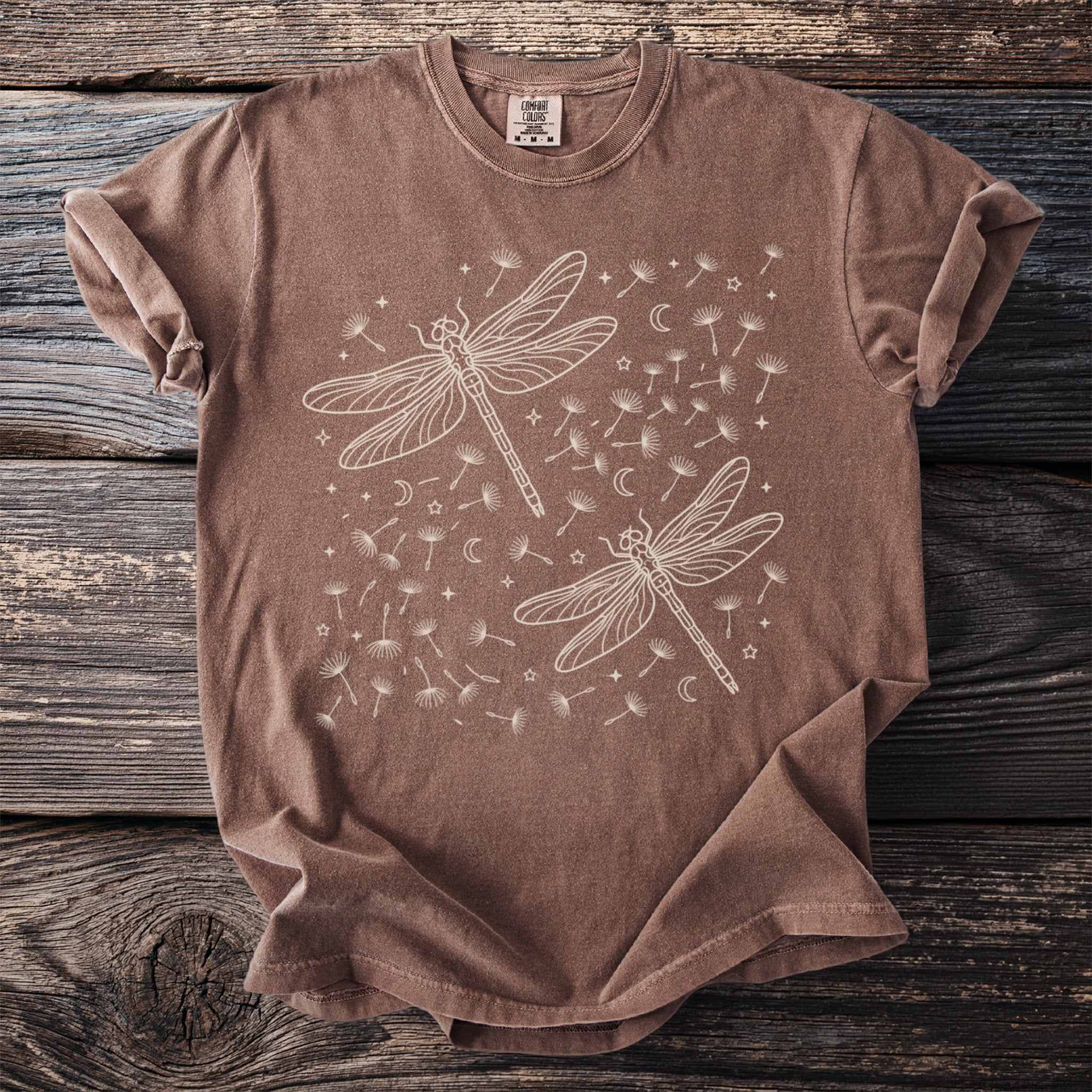 Brown t-shirt with cream dragonfly and dandelion seed print.